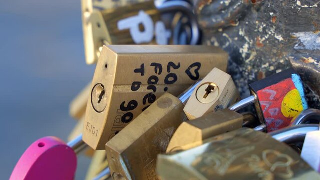 Close up on love locks hanging on the Pont des Arts bridge in Paris, France