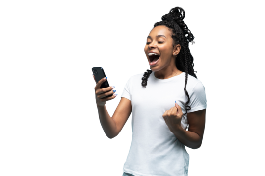 Positive curly haired ethnic woman uses mobile phone checks messages and reads news holds modern cellular in hands looks with curious happy expression isolated over transparent background