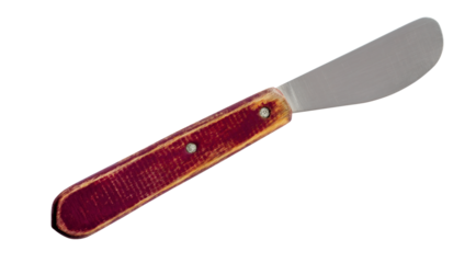 Old butter spreader knife with brown wooden handle isolated on white background