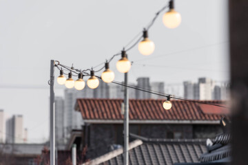 Warm light garland bulbs hanging on the rooftop. incandescent light bulb