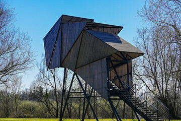 A charming wooden bird watching house nestled in the picturesque landscape of Lonjsko polje, showcasing the beauty of nature and the joys of bird watching.