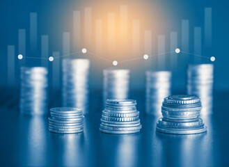 Money coin stack and stock trading market graph with blue filter. Financial background concept.