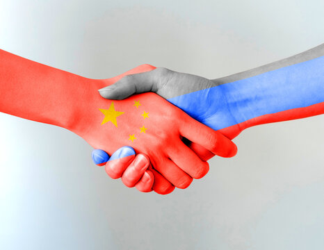 Handshake symbol in the colors of the national flags of China and Russia