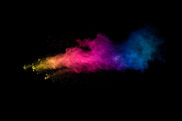 Abstract multi color powder explosion on black background.  Freeze motion of colorful dust ...