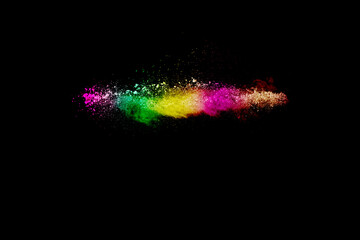 Abstract multi color powder explosion on black background.  Freeze motion of colorful dust ...