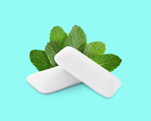 Menthol chewing gum pillows and mint leaves on cyan background