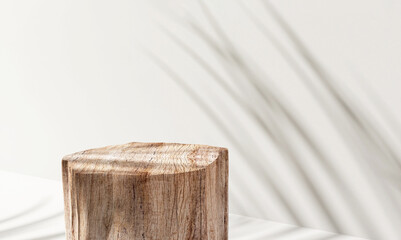 Minimal, natural log wood podium table in sunlight, palm leaf shadow in blank cream white wall,...