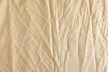 Crumpled beige fabric as background, top view