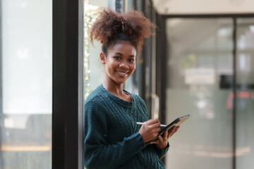 Woman student holding tablet preparing for online class.