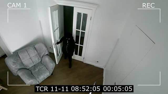 view from the surveillance camera. CCTV cameras capture a burglar entering the house.