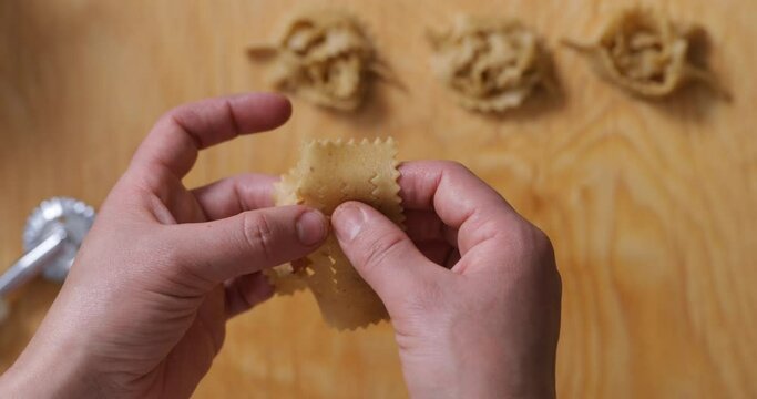Detailed mastery: zooming in on the skilled hands shaping chebakia dough, a feast for the senses