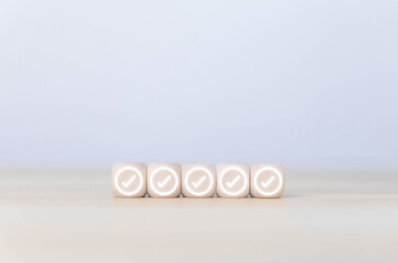 wooden block showing check mark Checklist ideas in business surveys and questionnaires copy space