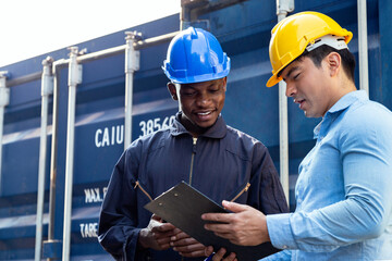 Warehouse business manager and port worker working and checking container after loading at...