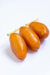 Close-up of Algerian royal dates isolated on white background. Ramadan concept. Delicious fruit.