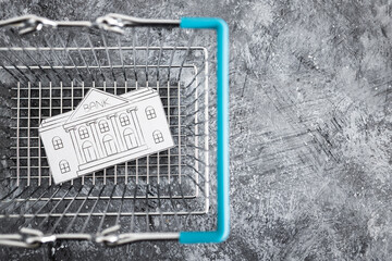 merging and holdings, bank made of paper inside of shopping basket ready to be bought by a...