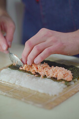 Making pink salmon sushi roll	
