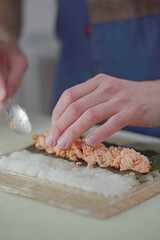 Making pink salmon sushi roll	