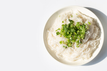 Rice noodles with spring onions and chopped coriander