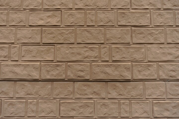 Surface of light brown painted brick veneer wall