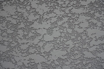 Macro of gray semi-smooth wall with stucco lace finish