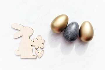 Wooden rabbit and easter eggs on a white background