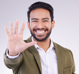 Portrait, smile and Asian man with stop, hand and communication against grey studio background....