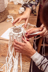 Obraz premium White macrame. Two young girls making macrame patterns