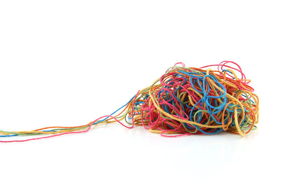 Tangled colorful cotton threads isolated on white background. Pile of knitting yarn threads.