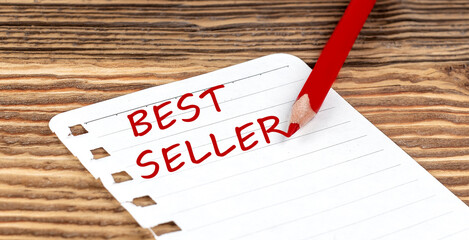 Word BEST SELLER on a paper with ped pencil on wooden background