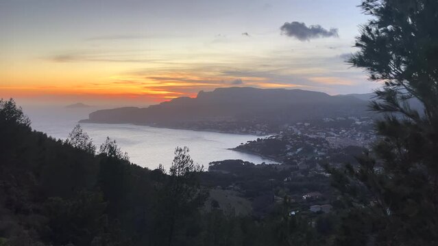 Colorful sunset over Cassis in France on a partly cloudy day. Steady shot