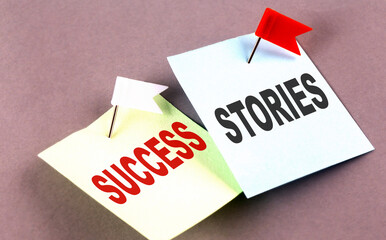 SUCCESS STORIES text on a sticky on grey background