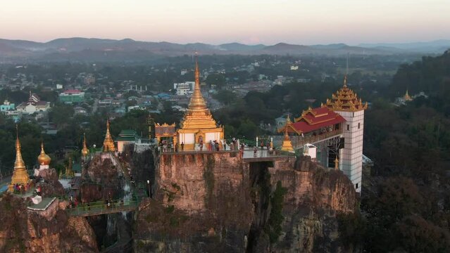 Visitors  enjoying the view from the Sri Mingala Taung Taw in Loikaw, Myanmar during sunset. Drone dolley tilt shot