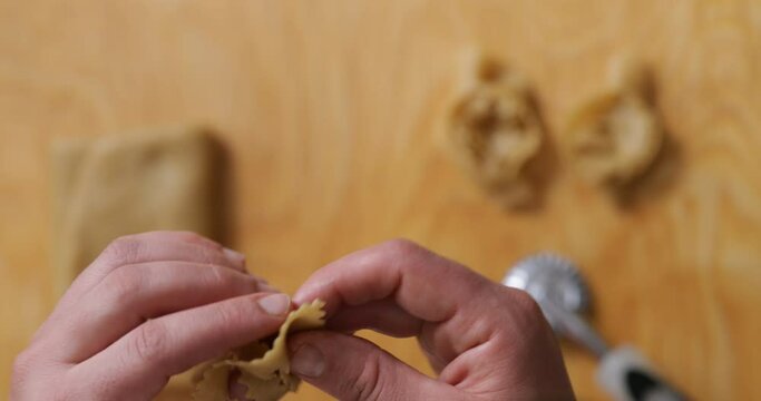 Macro magic unfolds: hands at work, expertly deforming chebakia dough into delightful, intricate shapes.