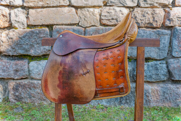 Vintage Italian military saddle preserved in a garden