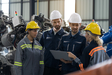 Industrial Manufacturing Robotic Arms Maintaining. Male, female engineer discuss, training inspecting quality parts of robotics arms for manufacturing lines in robotic assembly plant