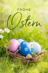 Happy Easter Card  - German text. Nest with Easter eggs in grass on a sunny spring day - Easter decoration, background  -  Copy space
