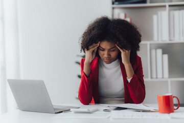 Young business woman worried about problem at work and stressed about problem with laptop computer.