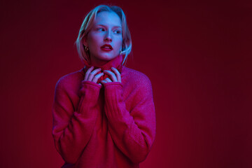 Headshot of a serious woman with pure natural skin posing on magenta background. Viva magenta, color of the year.