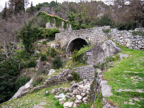 Old stone bridge in mountains surrounded with green bushes