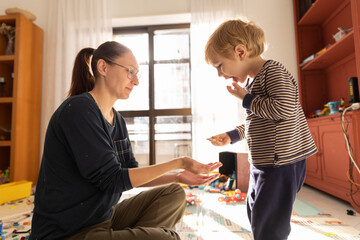 Mom and son eating cookies in the playroom