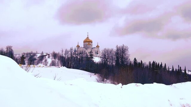 Belogorsky St. Nicholas Orthodox Missionary Monastery. Russia, Perm Krai, Belaya Gora. The temple on the hill in winter. Monastery on the background of snow. 4K
