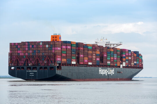 Stade, Germany – March 19, 2023: Container ship AL DAHNA EXPRESS owned and operated by Hapag-LLoyd on Elbe river heading to Hamburg. Rear view.
