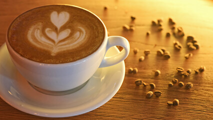 foamy latte with milk on wooden background