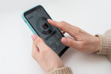 Fototapeta premium Woman holding phone with blank screen in hand
