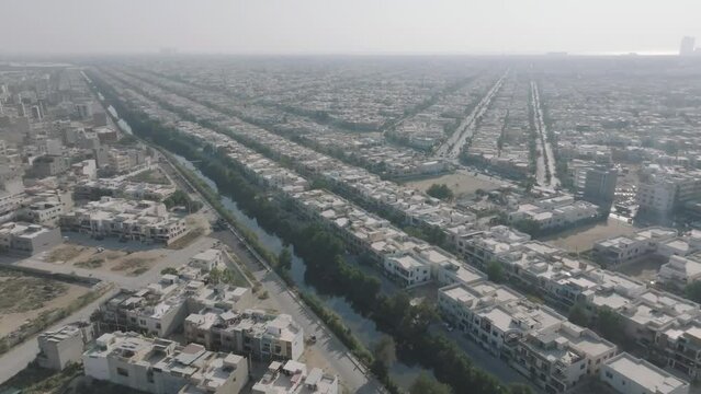 Aerial View Flying Over Rows Of Defence Housing Authority Cityscape In Karachi. Dolly Forward