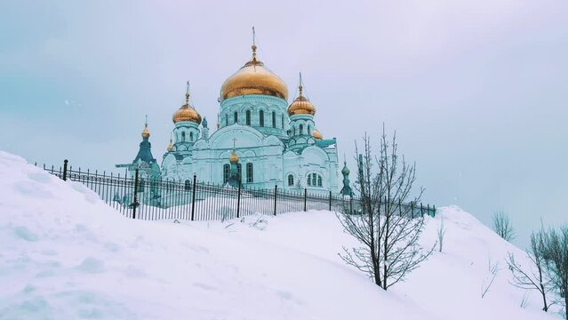 Belogorsky St. Nicholas Orthodox Missionary Monastery. Russia, Perm Krai, Belaya Gora. The temple on the hill in winter. Monastery on the background of snow. 4K