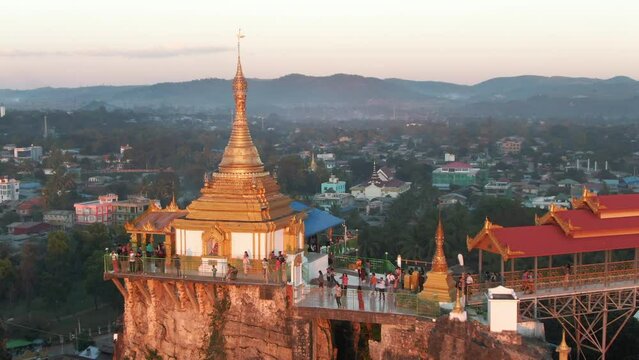 Visitors on Taw Kyet Pagoda in Myanmar. Drone lifting shotgreat view over Loikaw in Myanmar. Backwards drone dolley shot