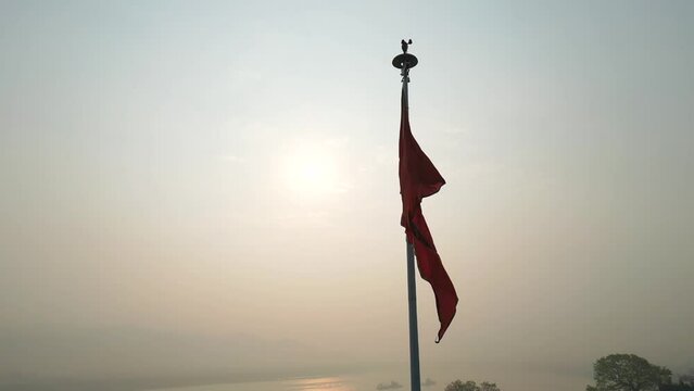 orange flag flying in ghodbunder fort closeup 180d slow motion view in mumbai