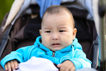 upset little asian kid with tearing in his eyes. crying infant boy. weaning. the end of...