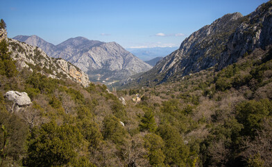 View from the top of the mountain to the green valley and the road at the foot of the mountain.